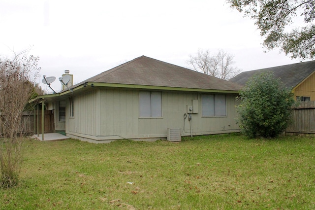 back of property featuring a yard