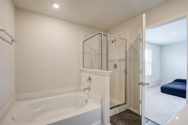 bathroom featuring separate shower and tub