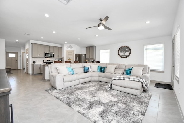 living room with light tile patterned flooring and ceiling fan