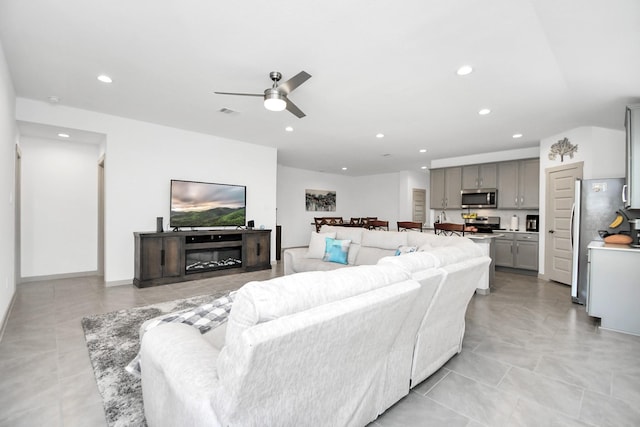 living room with light tile patterned flooring and ceiling fan