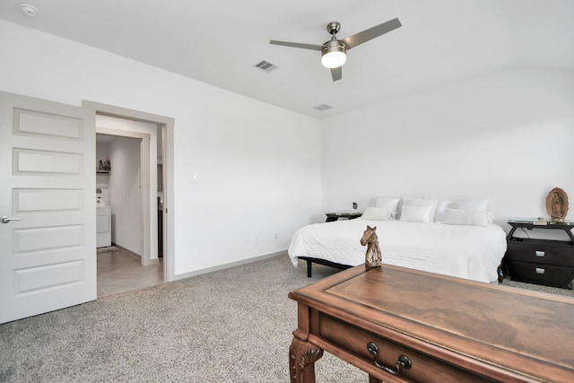 bedroom featuring washer / clothes dryer, lofted ceiling, light colored carpet, and ceiling fan