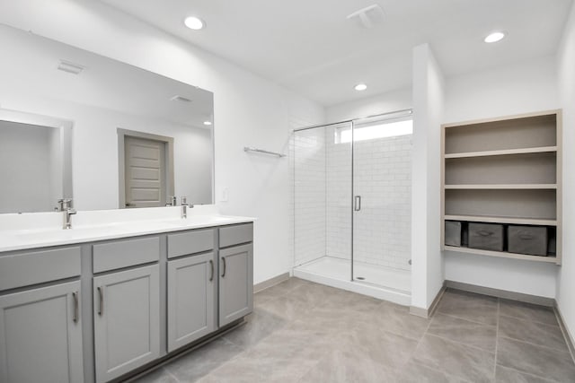 bathroom featuring vanity, tile patterned flooring, and a shower with door