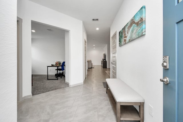 corridor with light tile patterned floors