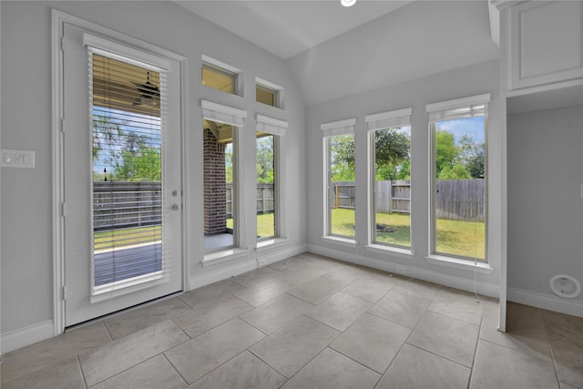 unfurnished sunroom featuring vaulted ceiling