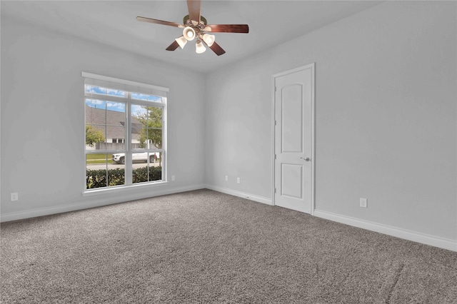 carpeted spare room with ceiling fan