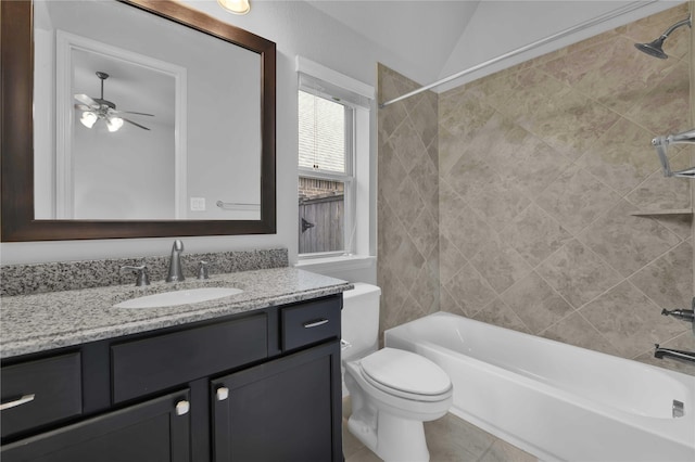 full bathroom with lofted ceiling, tile patterned flooring, tiled shower / bath combo, vanity, and toilet