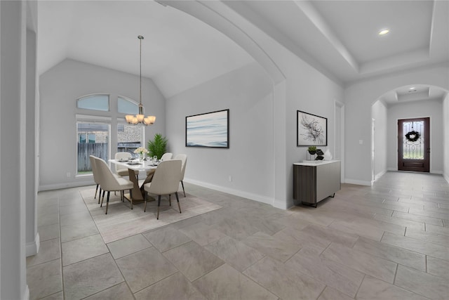 dining room featuring an inviting chandelier, high vaulted ceiling, and light tile patterned floors