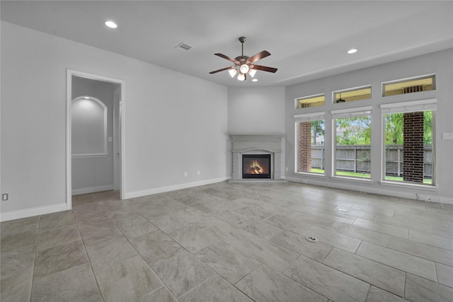 unfurnished living room featuring ceiling fan