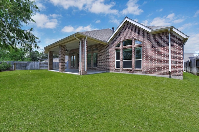 back of property with a patio and a lawn