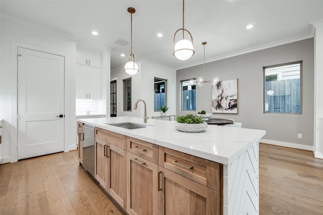 kitchen with sink, hanging light fixtures, dishwasher, light stone countertops, and a kitchen island with sink