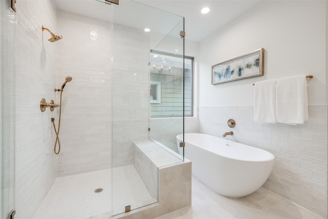 bathroom with plus walk in shower and tile walls