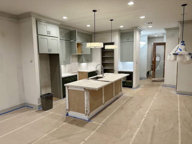 kitchen featuring gray cabinets, sink, decorative backsplash, hanging light fixtures, and a kitchen island with sink