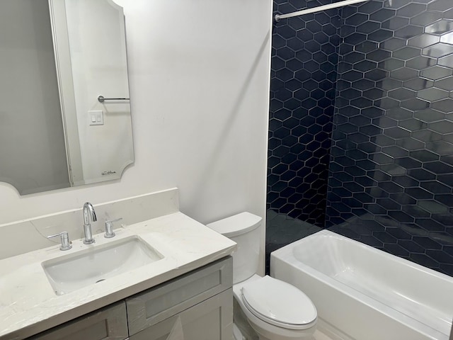 full bathroom featuring tiled shower / bath, vanity, and toilet