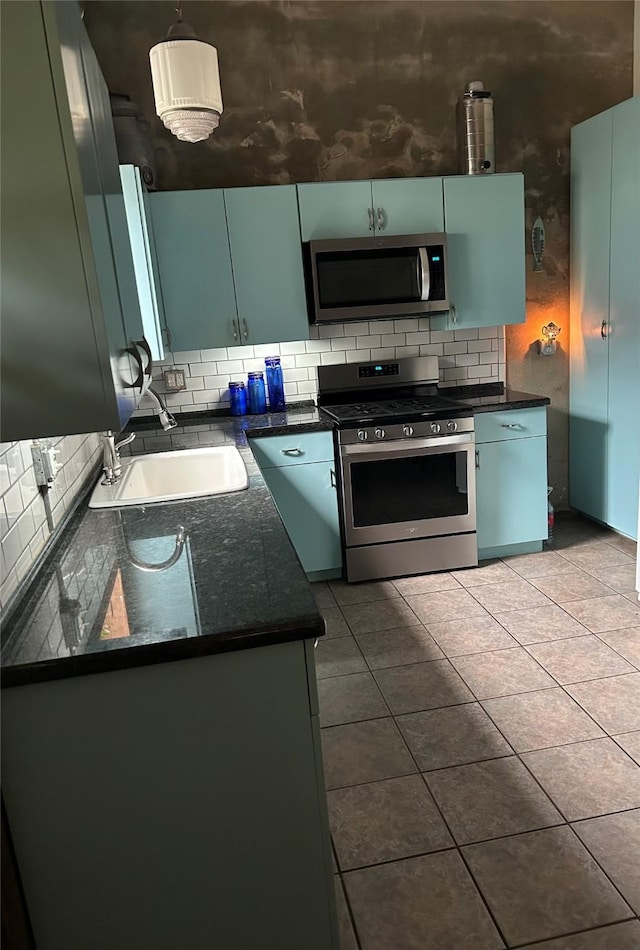 kitchen featuring light tile patterned flooring, stainless steel appliances, sink, and backsplash