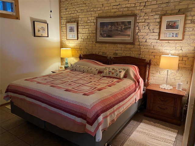 bedroom with light tile patterned flooring and brick wall