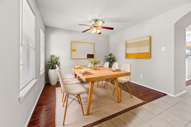 dining area with ceiling fan and wood-type flooring