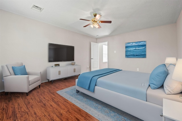 bedroom with visible vents, ceiling fan, and wood finished floors