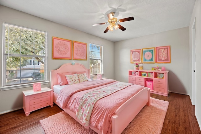 bedroom featuring dark hardwood / wood-style floors and ceiling fan