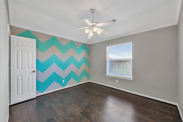 spare room with dark hardwood / wood-style flooring, crown molding, and ceiling fan