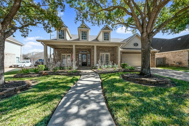 cape cod home featuring a garage, a front yard, french doors, and a porch