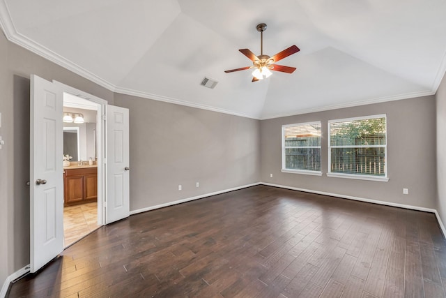 spare room featuring vaulted ceiling, dark wood-type flooring, ceiling fan, and crown molding