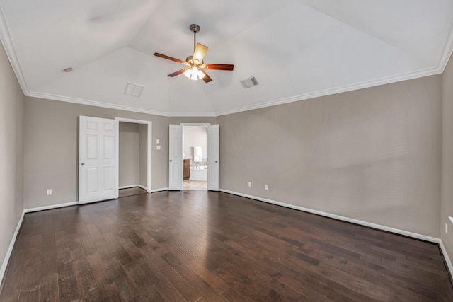 empty room featuring dark hardwood / wood-style flooring, crown molding, vaulted ceiling, and ceiling fan