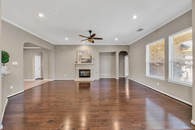 unfurnished living room with ornamental molding and dark hardwood / wood-style floors