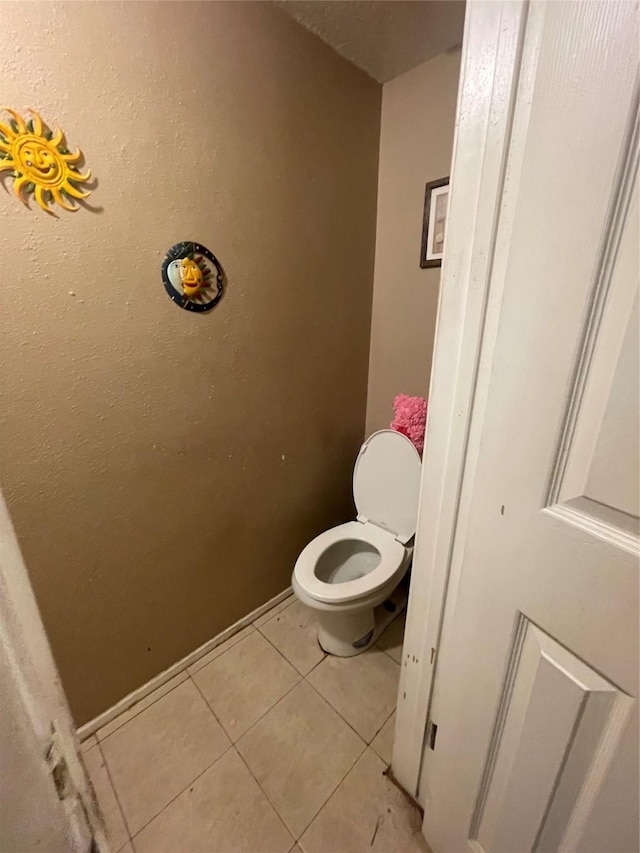 bathroom with tile patterned flooring and toilet