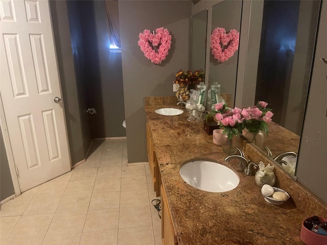 bathroom with tile patterned floors and vanity