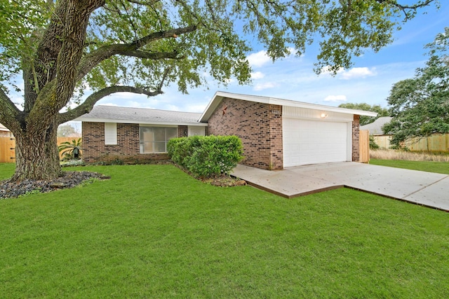 ranch-style home with a garage and a front yard