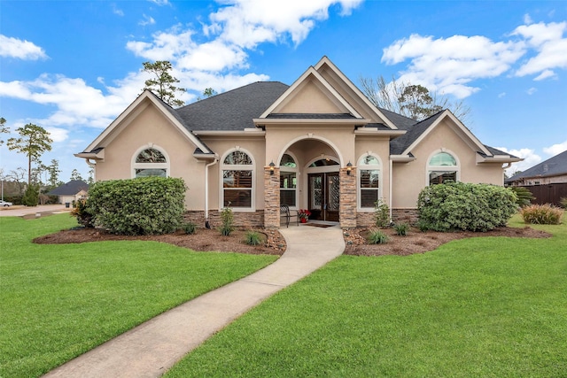 view of front of home with a front lawn and french doors