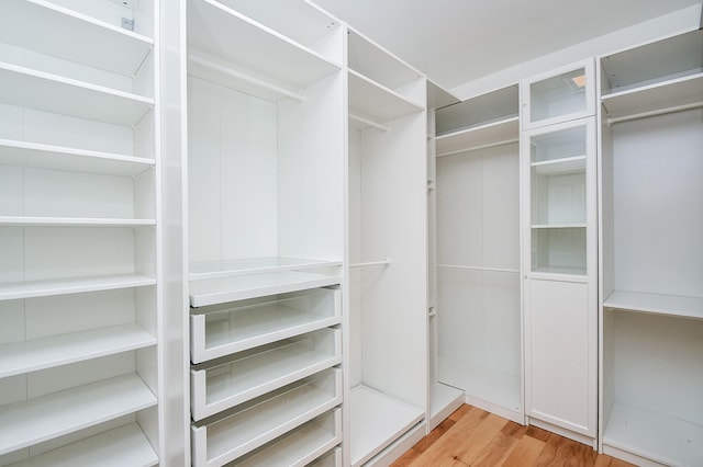 walk in closet featuring light hardwood / wood-style floors