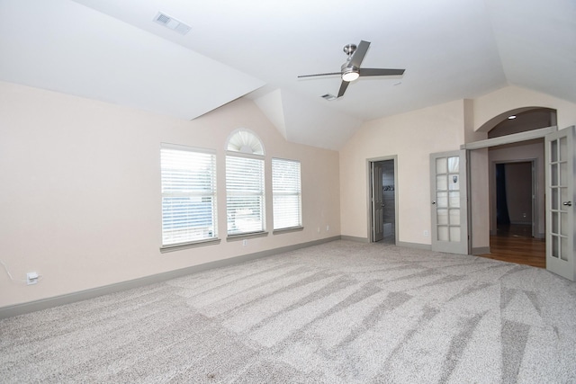 interior space with french doors, ceiling fan, carpet flooring, and vaulted ceiling