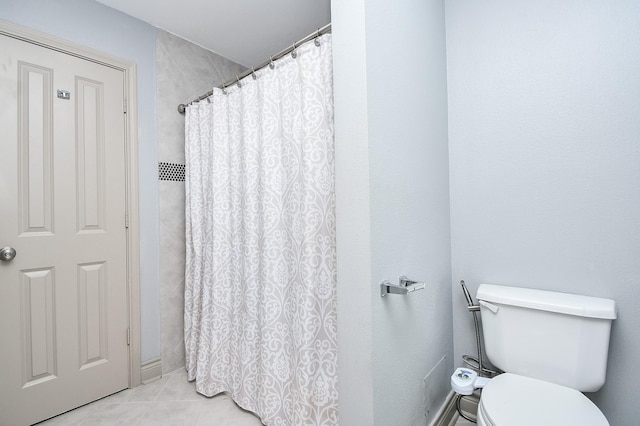 bathroom with walk in shower, tile patterned floors, and toilet