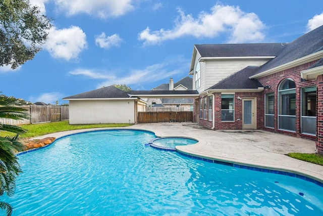 view of pool with a patio area and an in ground hot tub