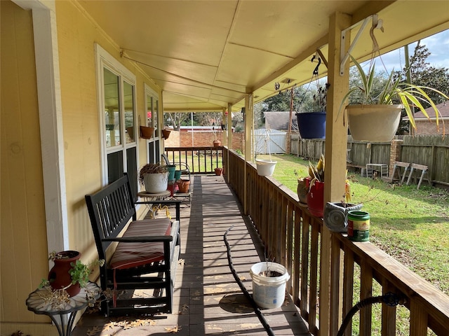 wooden deck featuring a yard