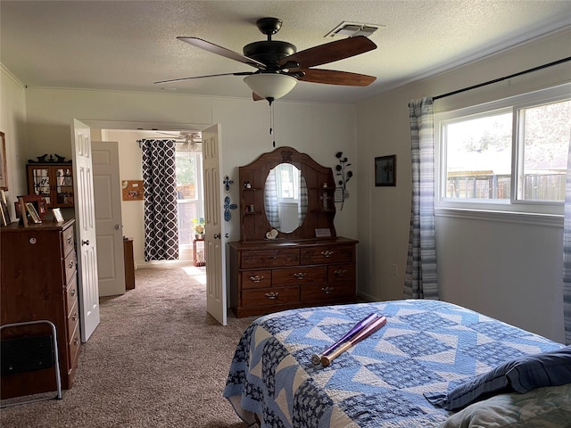 carpeted bedroom with ceiling fan and a textured ceiling