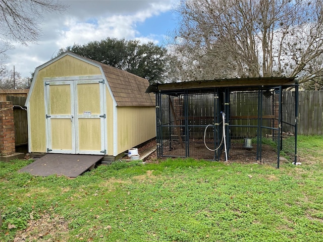 view of outbuilding featuring a yard