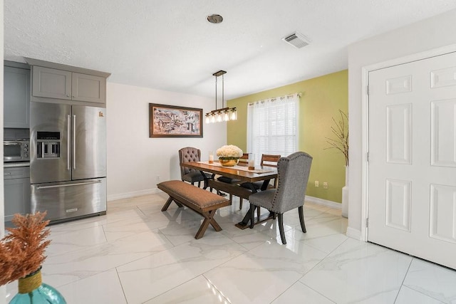 dining room featuring a textured ceiling