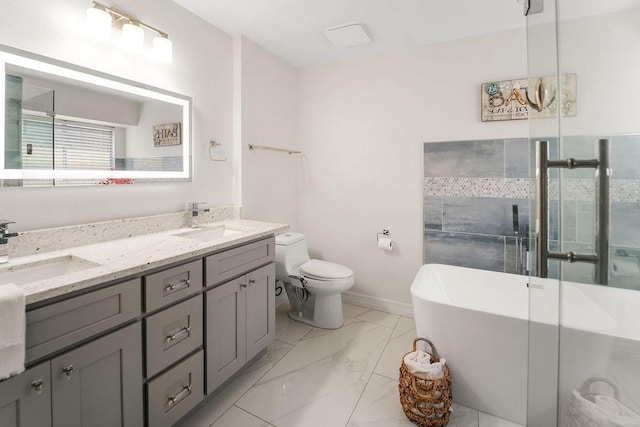 bathroom featuring vanity, toilet, and a tub to relax in