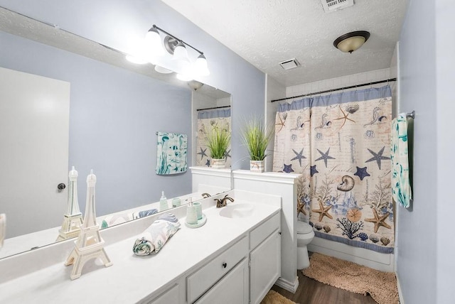 full bathroom with toilet, a textured ceiling, vanity, shower / bathtub combination with curtain, and hardwood / wood-style flooring