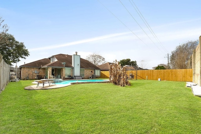 view of yard with a fenced in pool and a patio