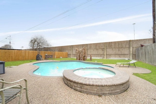 view of pool featuring a yard, a patio, and an in ground hot tub