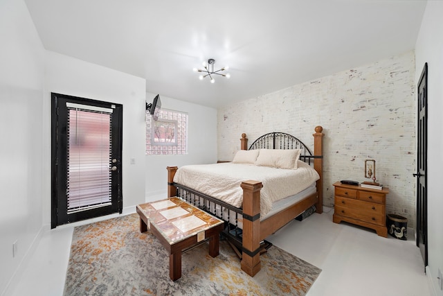 bedroom with an inviting chandelier and access to outside