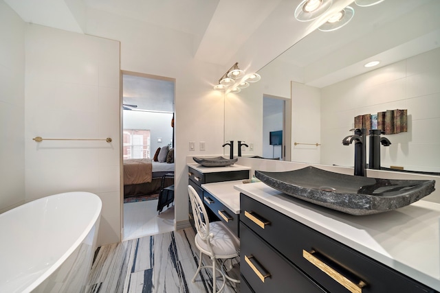 bathroom with vanity and a tub