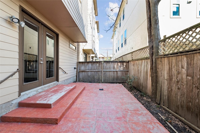 view of patio with french doors and a fenced backyard