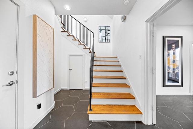 stairs with baseboards, tile patterned flooring, and recessed lighting