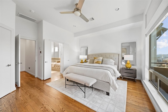 bedroom featuring ceiling fan, visible vents, and light wood-style floors