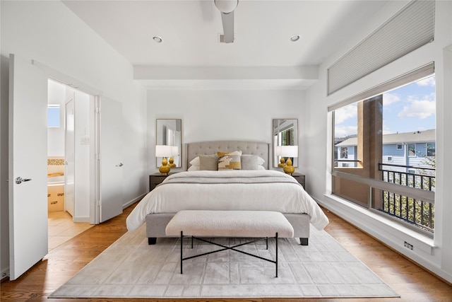 bedroom with access to exterior, connected bathroom, and light wood finished floors