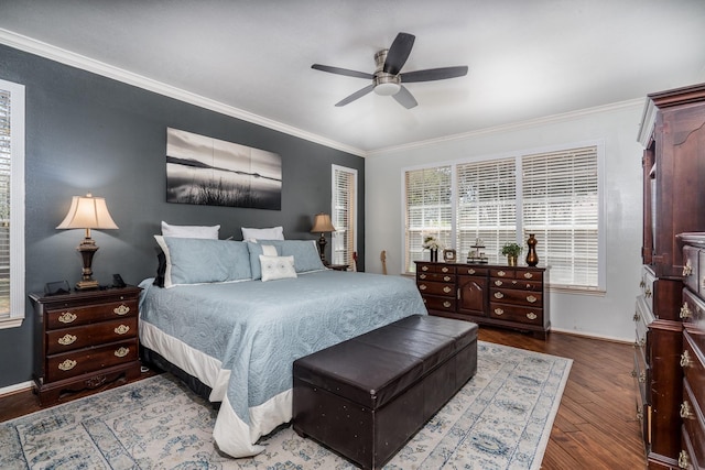 bedroom with crown molding, hardwood / wood-style floors, and ceiling fan